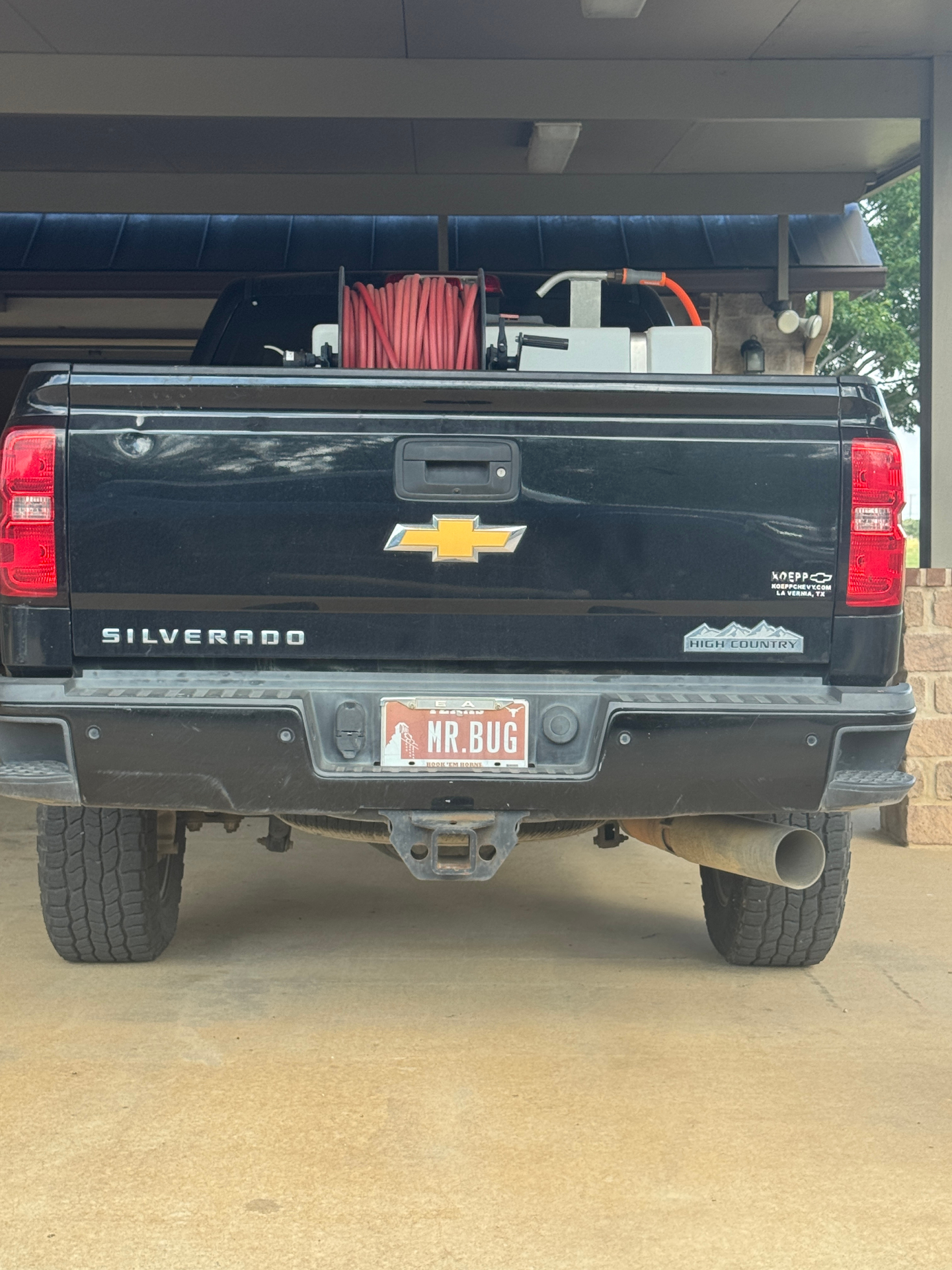 Rear of Bug World Exterminating service truck with professional spray rig equipment
